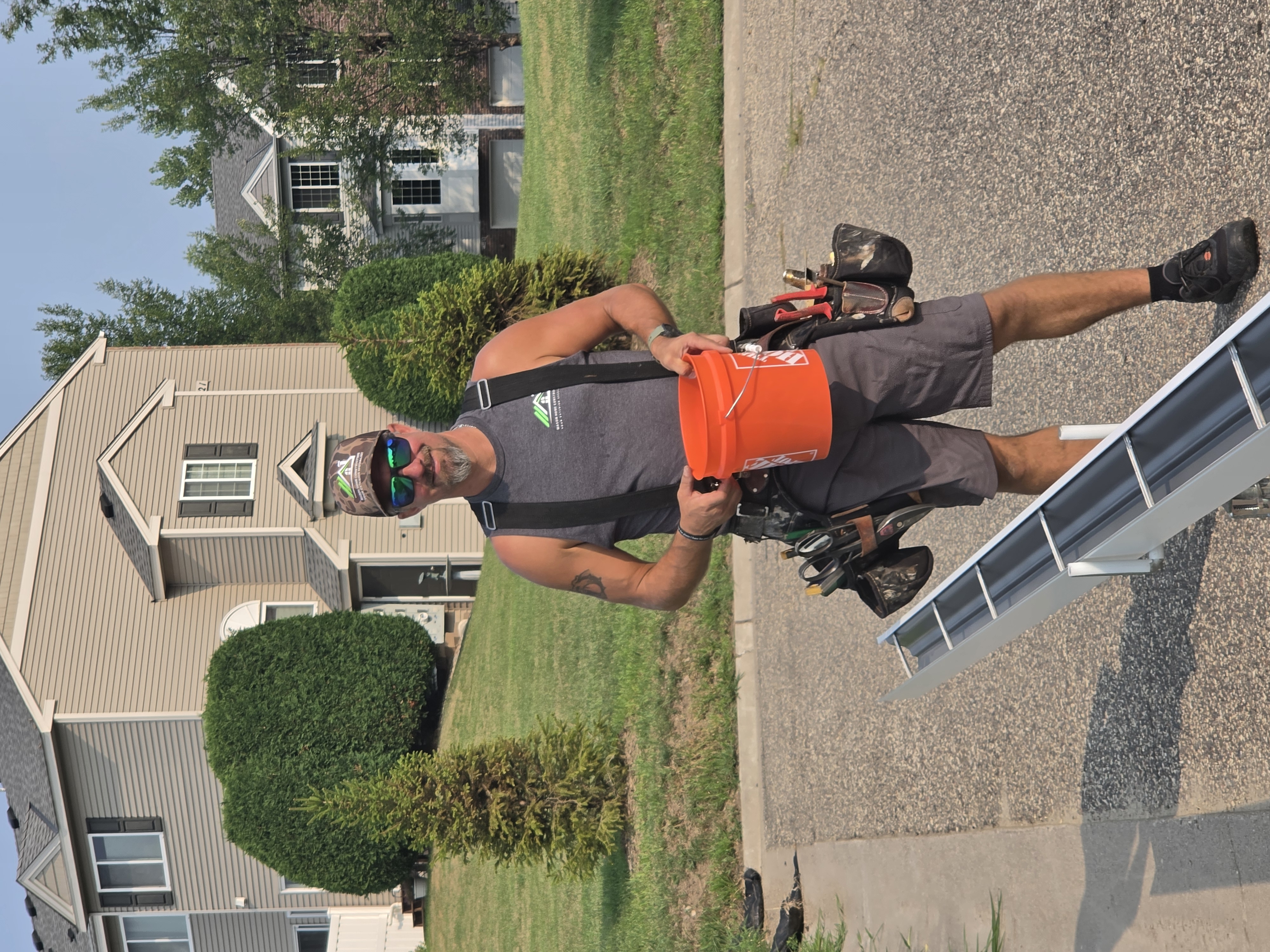 Jordan on the job beside gutter materials and equipment