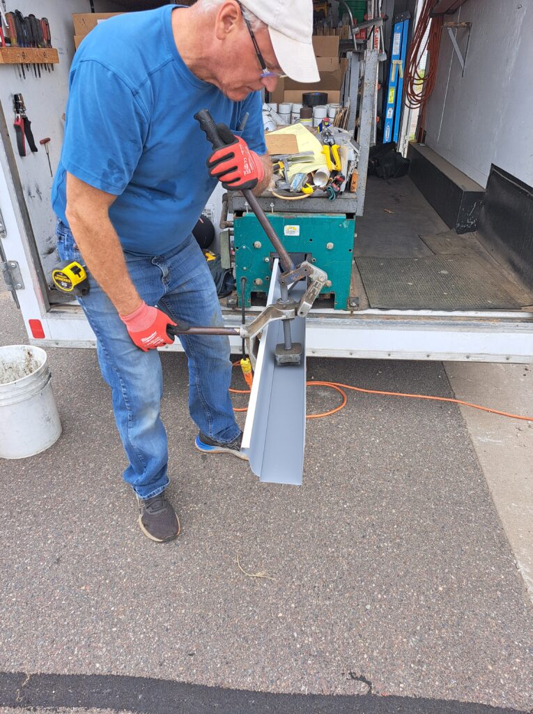Seamless gutter being formed for installation