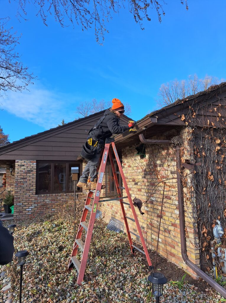 Nordick gutter installer working on a home